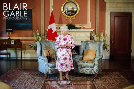Queen Elizabeth sitting in upholstered chair